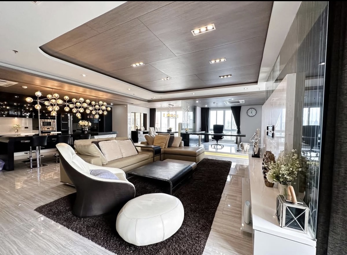 Luxury 3-bedroom penthouse for rent near BTS Asoke, 240 sqm with large walk-in closet, modern kitchen, office space, city view balconies, and premium facilities. 150,000 THB/month.