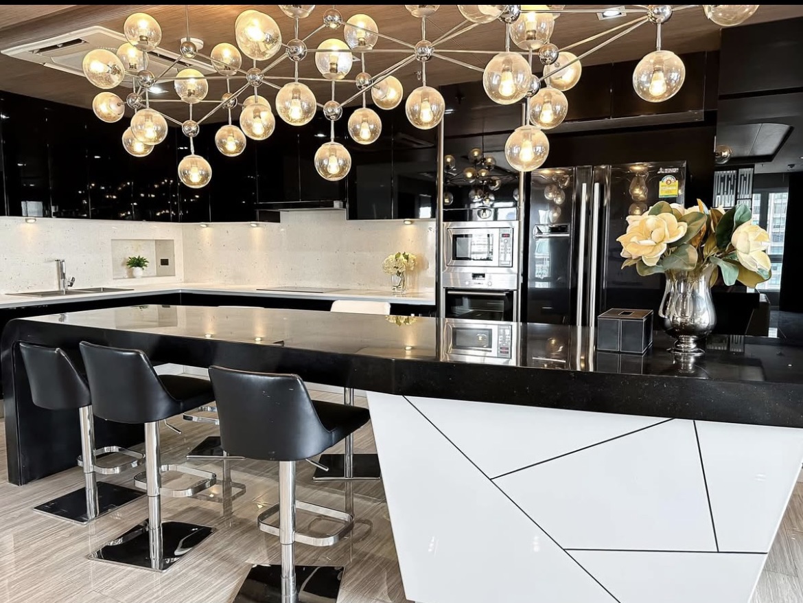 Luxury 3-bedroom penthouse for rent near BTS Asoke, 240 sqm with large walk-in closet, modern kitchen, office space, city view balconies, and premium facilities. 150,000 THB/month.