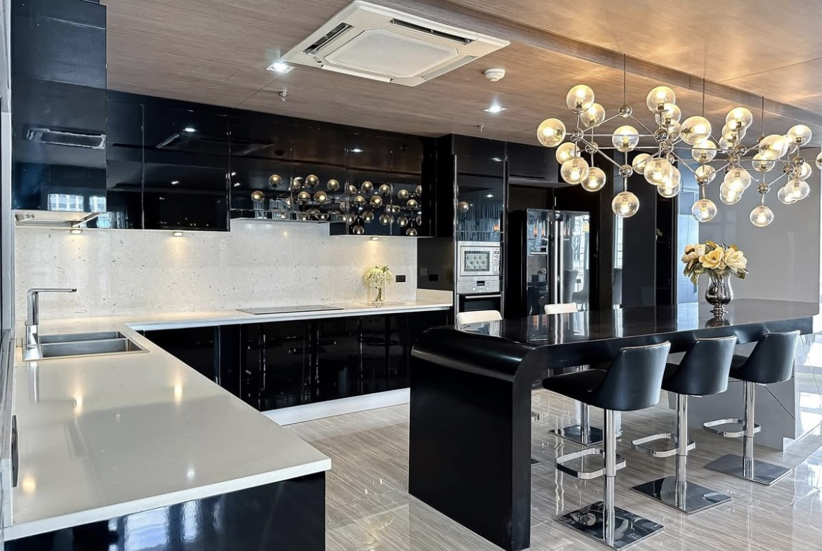 Luxury 3-bedroom penthouse for rent near BTS Asoke, 240 sqm with large walk-in closet, modern kitchen, office space, city view balconies, and premium facilities. 150,000 THB/month.