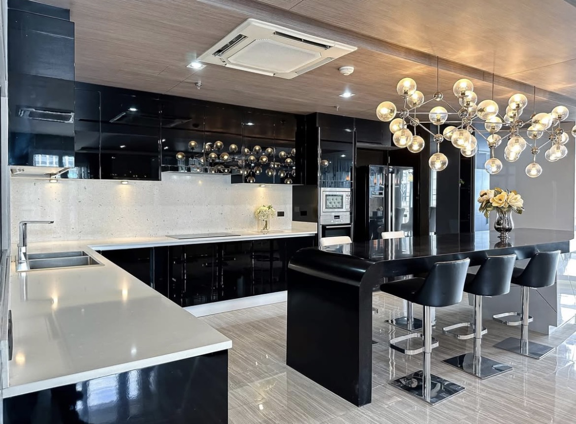 Luxury 3-bedroom penthouse for rent near BTS Asoke, 240 sqm with large walk-in closet, modern kitchen, office space, city view balconies, and premium facilities. 150,000 THB/month.