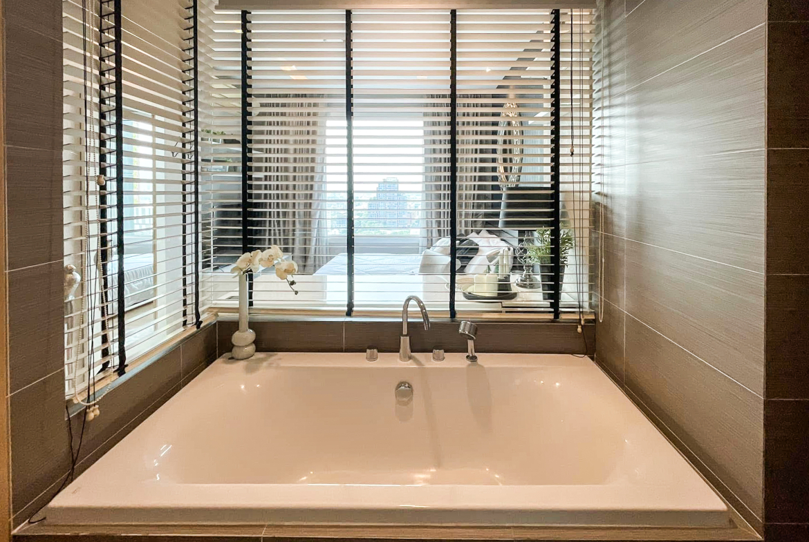 Luxury 2-bedroom condo at SIRI at Sukhumvit for rent and sale. Just 2 minutes walk to BTS Thong Lor. 24th floor with pool view, fully furnished, modern design. Rent 65,000 THB/month or buy for 15.5M THB.