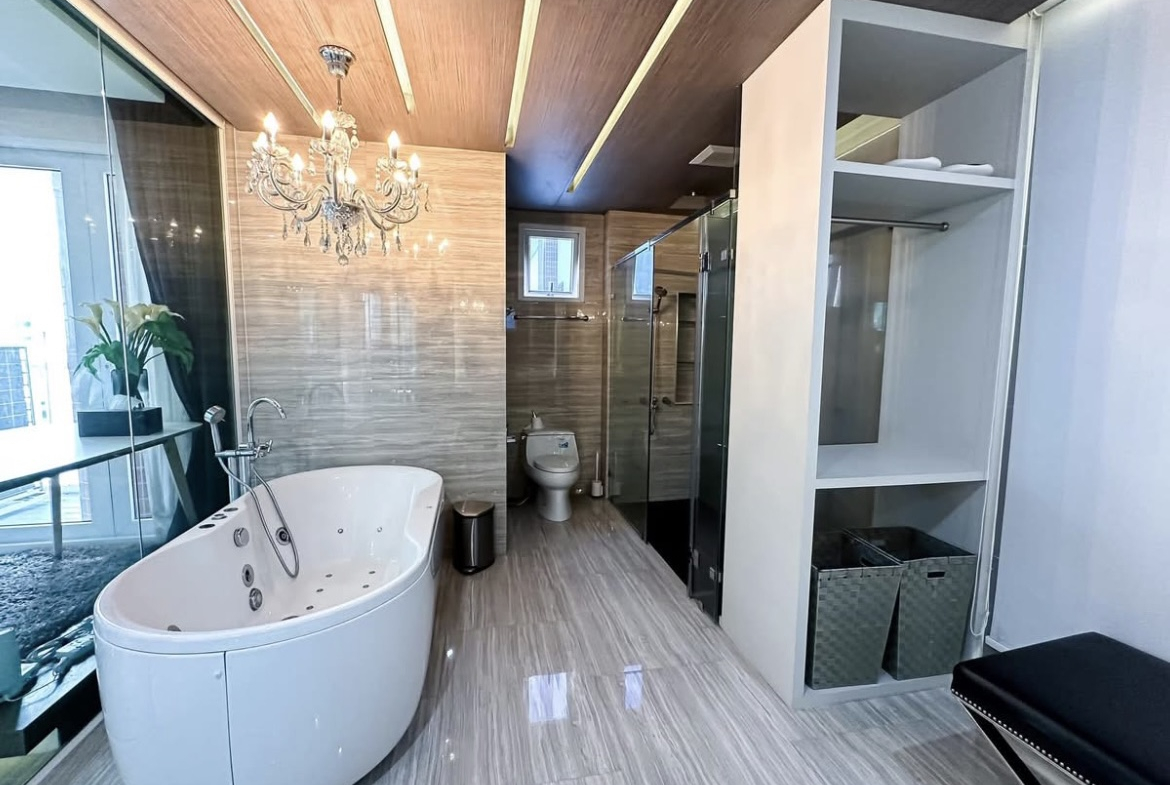 Luxury 3-bedroom penthouse for rent near BTS Asoke, 240 sqm with large walk-in closet, modern kitchen, office space, city view balconies, and premium facilities. 150,000 THB/month.