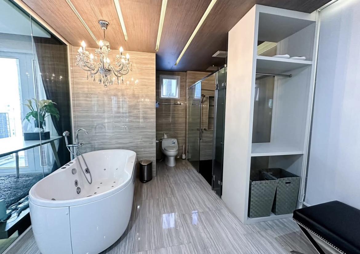 Luxury 3-bedroom penthouse for rent near BTS Asoke, 240 sqm with large walk-in closet, modern kitchen, office space, city view balconies, and premium facilities. 150,000 THB/month.
