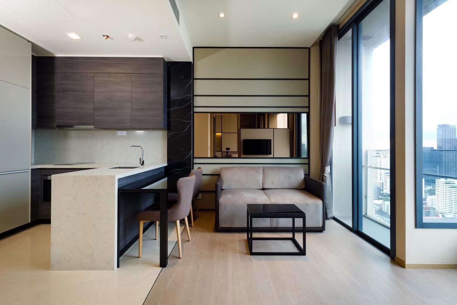 Rent this luxury 1-bedroom condo at The Esse Asoke, 32nd floor with skyline views, built-in furniture, and prime MRT/BTS access. Only 40,000 THB/month.