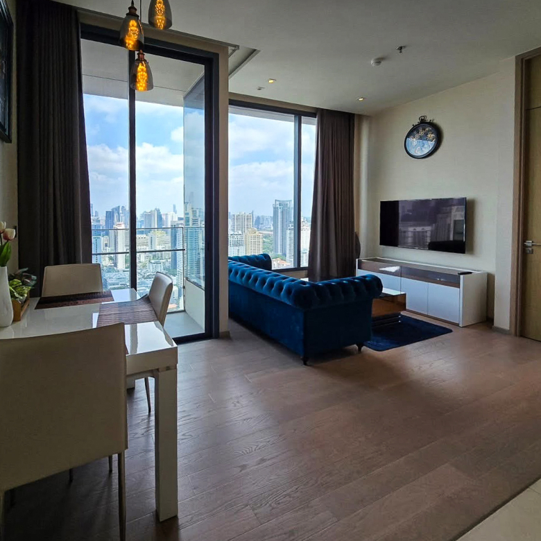 For sale: Luxury 2-bed, 2-bath condo at The Esse Asoke, 34th floor with unblocked west view, fully furnished, 2 car parks. Prime location on Asoke Road. 20M THB.