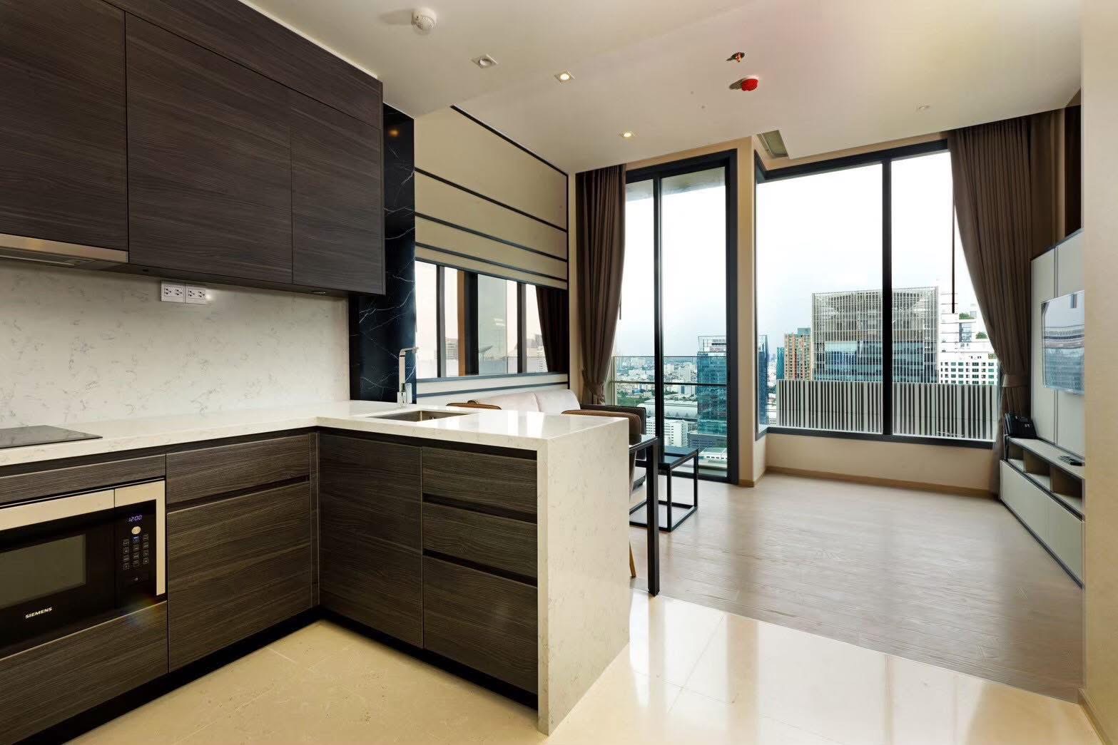 Rent this luxury 1-bedroom condo at The Esse Asoke, 32nd floor with skyline views, built-in furniture, and prime MRT/BTS access. Only 40,000 THB/month.