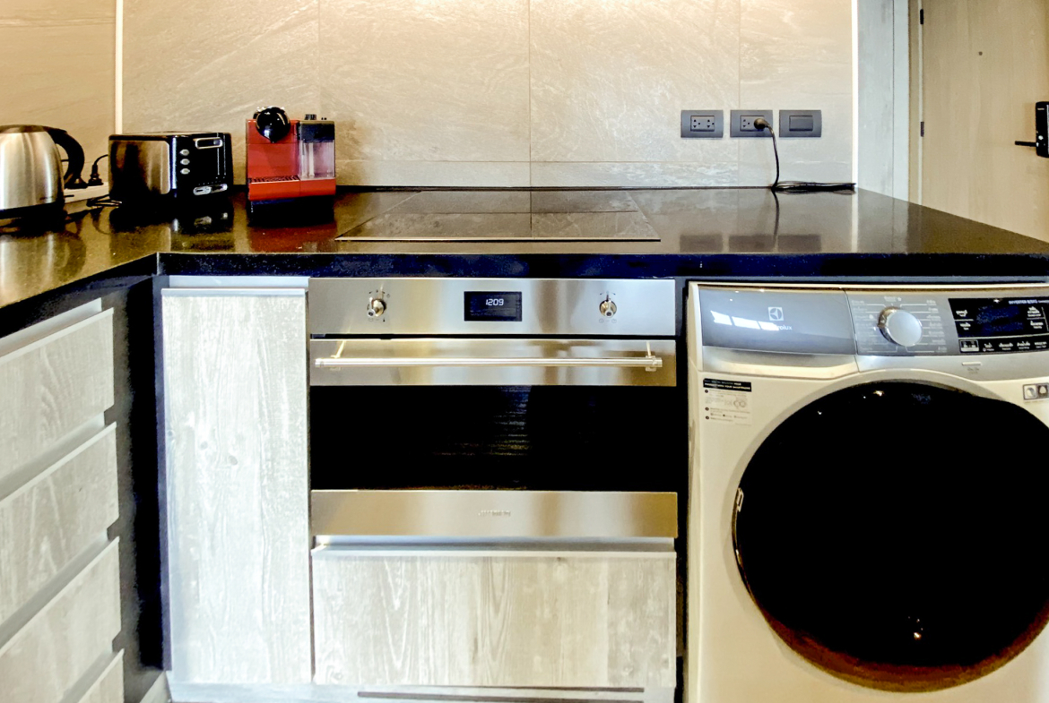 Rent this high-floor 2-bedroom condo at The Lofts Asoke with stunning city views, premium appliances, and luxury amenities. Prime Asoke location. 65,000 THB/month.