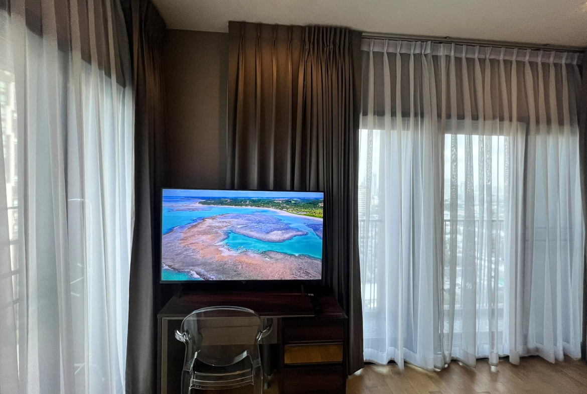 Spacious 2-bedroom, 2-bathroom condo for rent at Noble Reveal Ekkamai. Only 300m from BTS, fully furnished, 75 sqm, with indoor pool and gym. Rent: 60,000 THB/month.